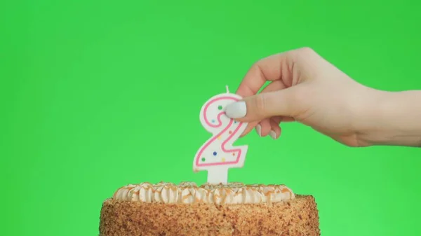 Anzünden einer Geburtstagskerze Nummer vier auf einem leckeren Kuchen, Green Screen 2 — Stockfoto