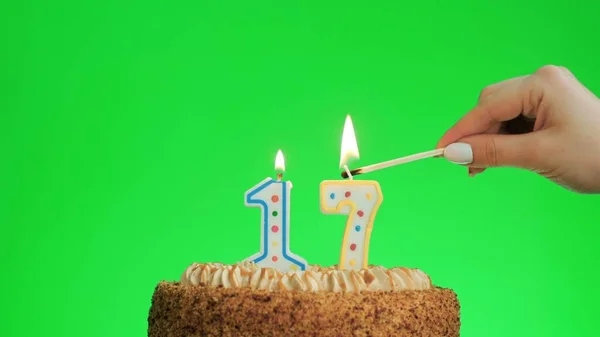 Iluminando uma vela de aniversário número quatro em um delicioso bolo, tela verde 17 — Fotografia de Stock