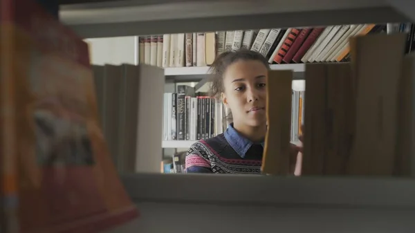 Jovem mulher americana africana bonita na biblioteca da escola — Fotografia de Stock