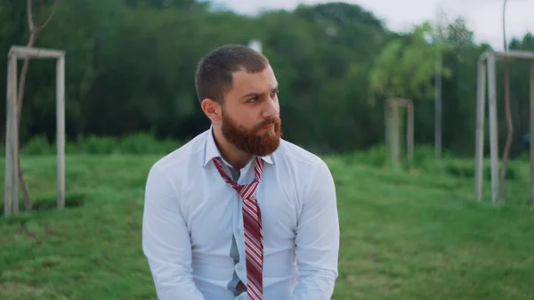 Yorgun işadamı parkta bankta oturuyor.