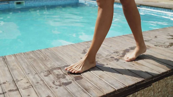 Vicino uo di gambe femminili passeggiate vicino alla piscina — Foto Stock