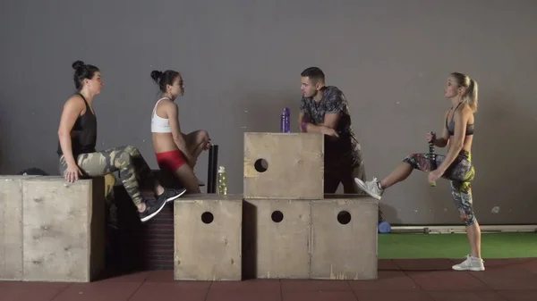 Gruppo di amici che parlano insieme dopo un allenamento in palestra — Foto Stock