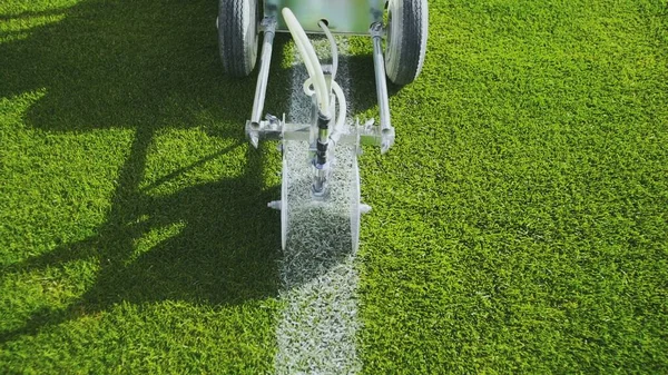 Marking football stadium field using a professional paint machine Royalty Free Stock Images