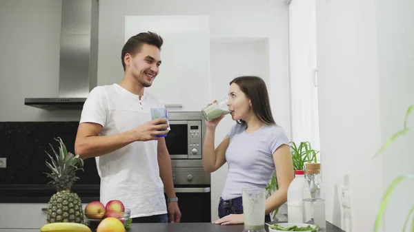 La familia joven por la mañana bebiendo el batido hortalizas de las frutas con la leche para el desayuno tienen una vida sana y el cuerpo — Foto de Stock