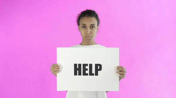 Afro-American Girl Activist With HELP Poster on pink background — Stock Photo, Image