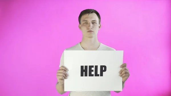 Young Man Activist With HELP Poster on pink background — Stock Photo, Image