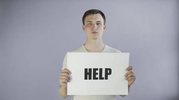 Young Man Activist With HELP Poster on grey background — Stock Photo, Image