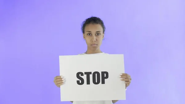 Afro-American Girl Activist With Stop Poster on Violet background — Stock Photo, Image