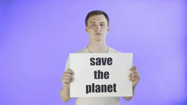 若い男の活動家とともにSave The Planet Poster on Violet background — ストック写真