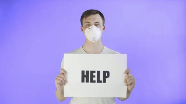 Young Man Activist With mask on face and with HELP Poster on Violet background — Stock Photo, Image