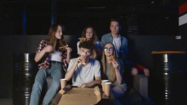 Öğrenciler film izliyor ve geceleri pizza yiyorlar.