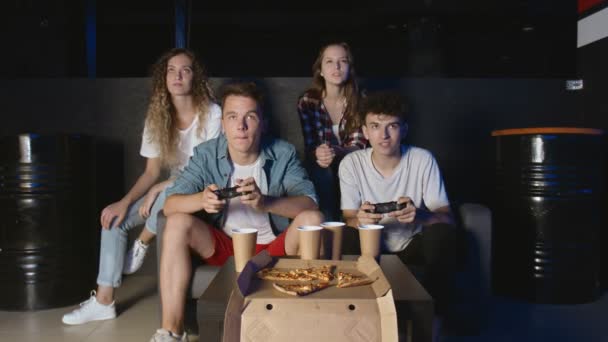 Friends are having fun with video game at home, one boy is winning laughing and doing high-five, another guy is upset. — Stock Video