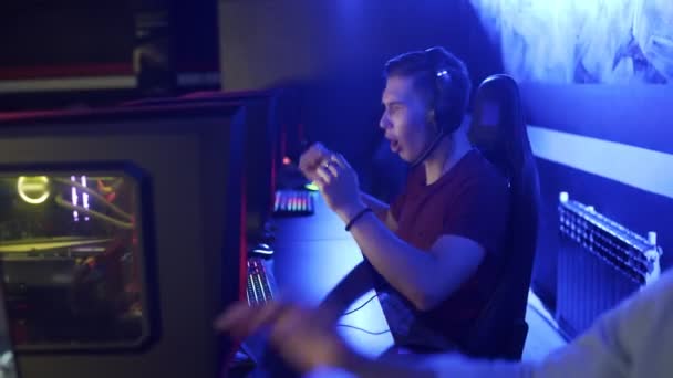 Deux jeunes joueurs masculins dans les casques jouer et gagner dans le jeu vidéo en ligne eSport Cyber Games Concept. — Video