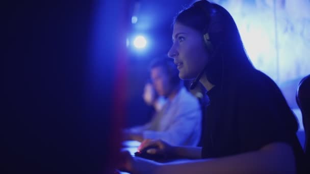 Συγκεντρωμένη νεαρή γυναίκα παίζουν σε ένα κλαμπ υπολογιστή, online παιχνίδι από την ομάδα. — Αρχείο Βίντεο