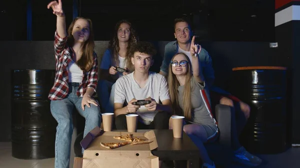 Jeune homme heureux complète le niveau dur dans le jeu vidéo. S'amuser avec des amis. — Photo