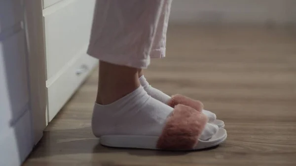 Woman getting out of bed, put on slippers — Stock Photo, Image