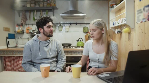 Happy couple having breakfast. Young man brings coffee to his girlfriend or wife — Stock Photo, Image