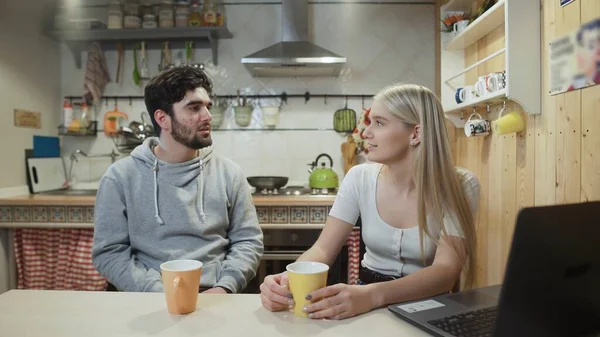 Happy couple having breakfast. Young man brings coffee to his girlfriend or wife — Stock Photo, Image