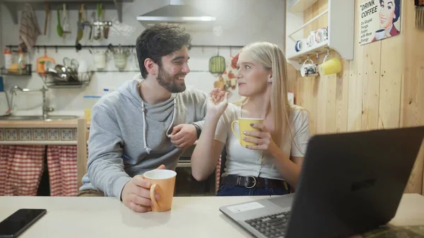 Lovely couple talking and laughing during breakfast in the kitchen — Stock Photo, Image