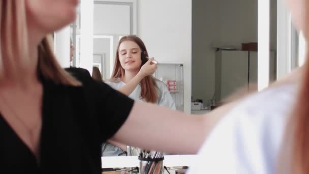 Make-up-Artist verwendet großen Pinsel, um Puder auf das Gesicht ihrer Kunden aufzutragen — Stockvideo