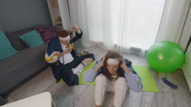 Kız arkadaşı karın kası egzersizi yaparken Retro stil genç adam pizza yiyor.