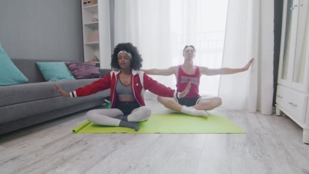 Cheerful Happy Caucasian man and african american woman retro style models meditation at home — Stock Video