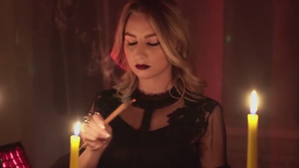 Female fortune teller lights magic incense for paranormal ritual — Stock Video