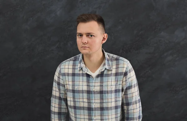 Suspicious young man looks doubtfully — Stock Photo, Image