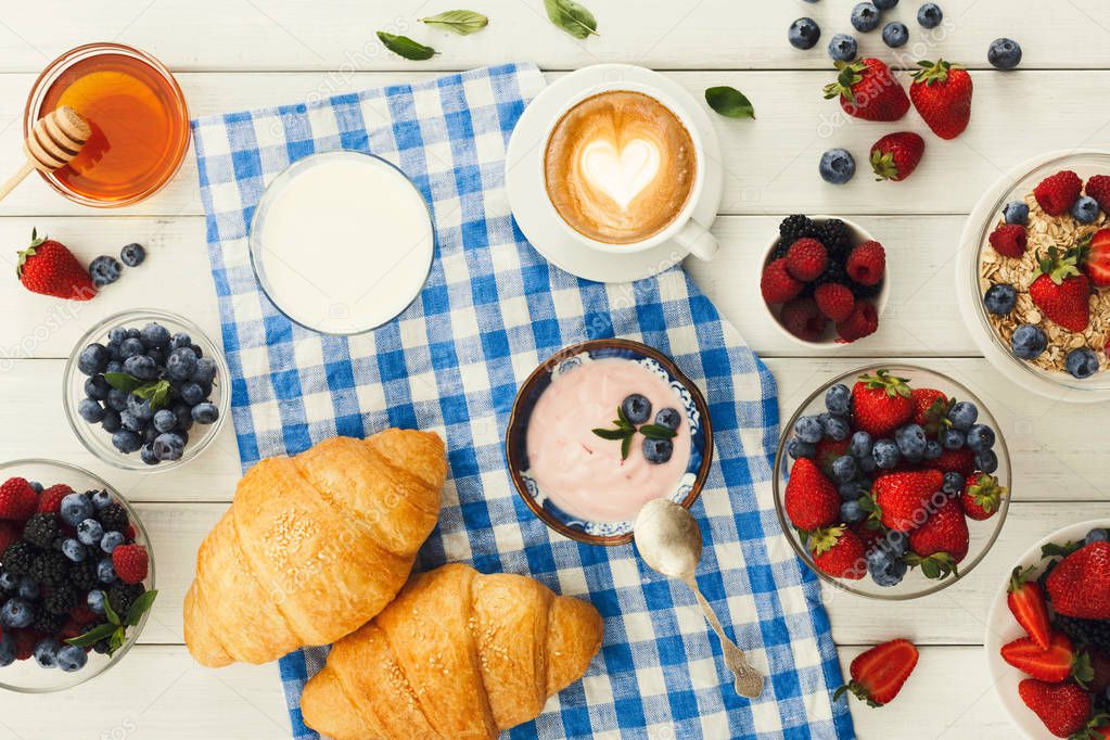 Continental breakfast with croissants and berries on checkered c