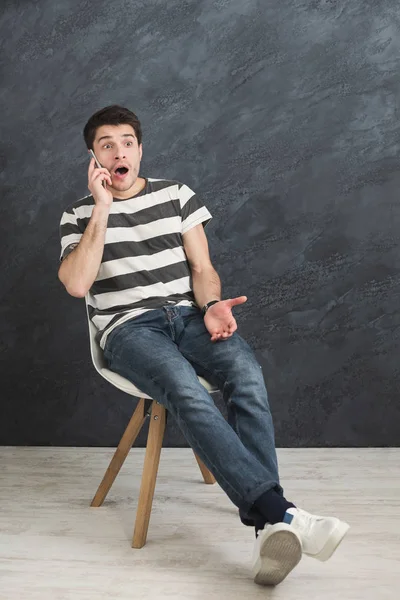 Worried man talking on phone in studio