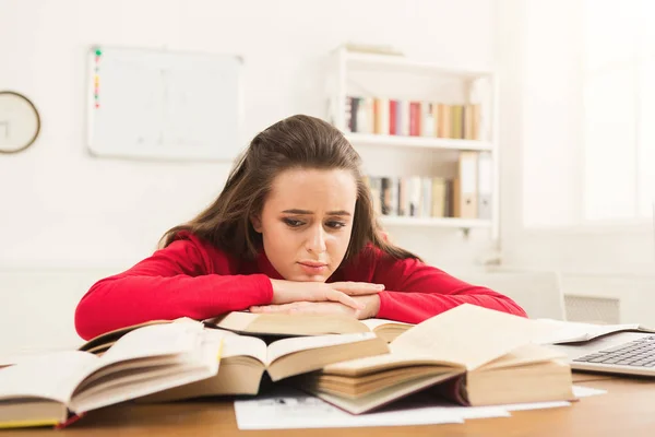 Estudante menina estudando na mesa cheia de livros — Fotografia de Stock