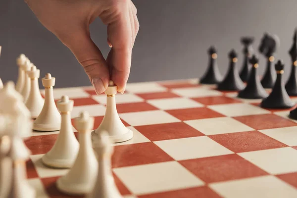 Hand of player chess board game putting white pawn — Stock Photo, Image