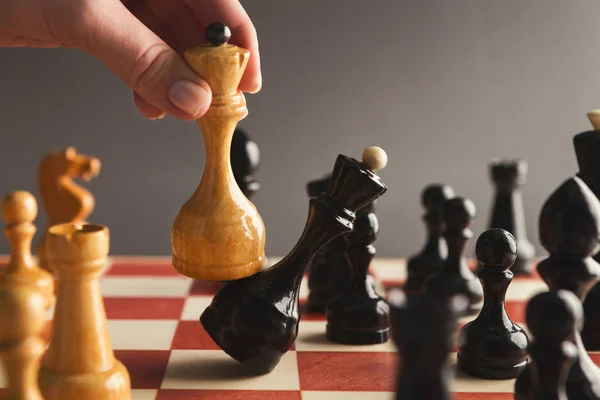 Hand take checkmate on chessboard during game — Stock Photo, Image