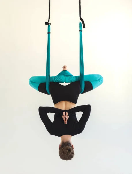 Woman practicing fly yoga over white background — Stock Photo, Image