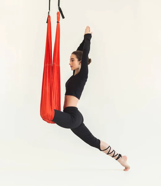 Woman practicing fly yoga over white background