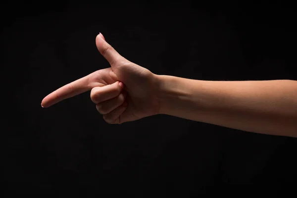 Handgesten - Frau zeigt, isoliert auf schwarz — Stockfoto