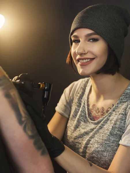 肩に刺青をしている若い女性彫師 — ストック写真