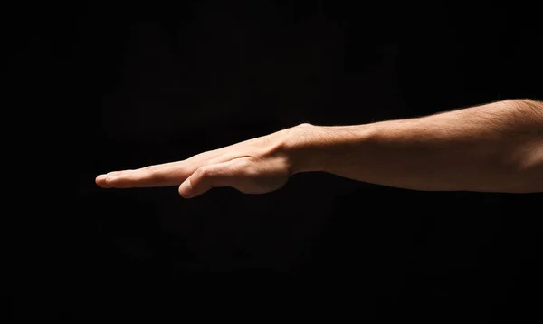 Mão masculina forte no fundo isolado preto — Fotografia de Stock