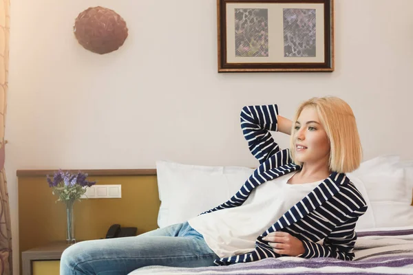 Jovem mulher sentada no quarto do hotel — Fotografia de Stock