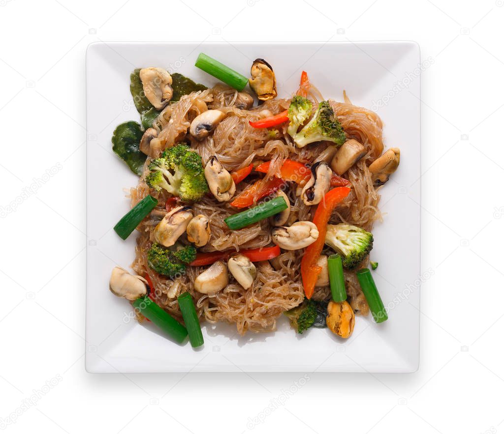 Asian restaurant healthy food delivery. Funchoza with mushrooms and vegetables, soy sauce, chilli pepper and cilantro on square platter isolated on white background, top view