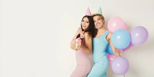 Happy girls with balloons having fun over white background — Stock Photo, Image
