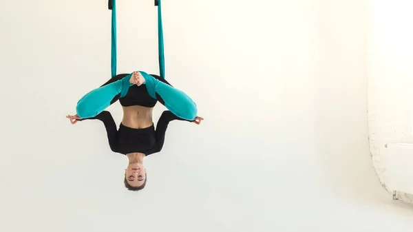 Woman practicing fly yoga over white background — Stock Photo, Image