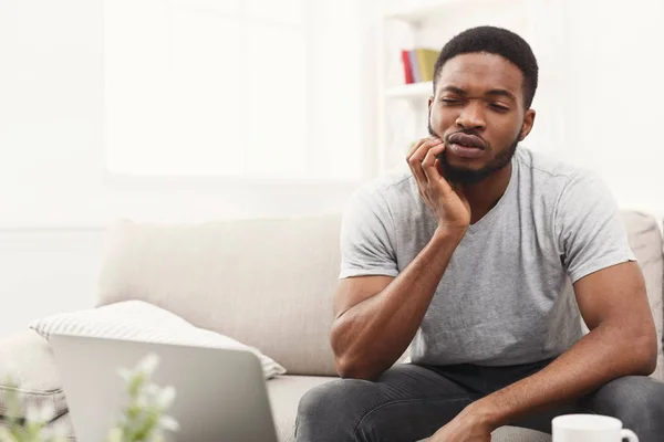 Young african-american man having toothache at home — Stock Photo, Image