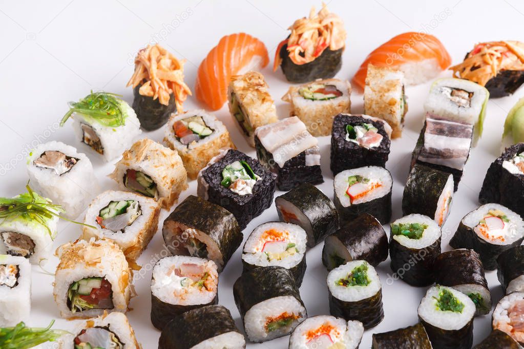 Set of sushi, maki and rolls on white