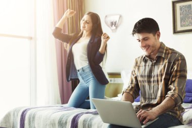 Dizüstü bilgisayarda müzik kadın çalışan genç adam