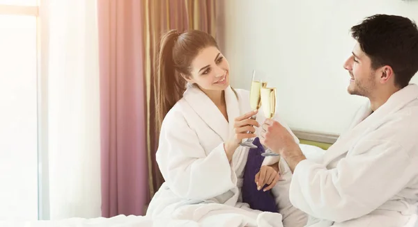 Романтическая пара пьет шампанское в постели — стоковое фото