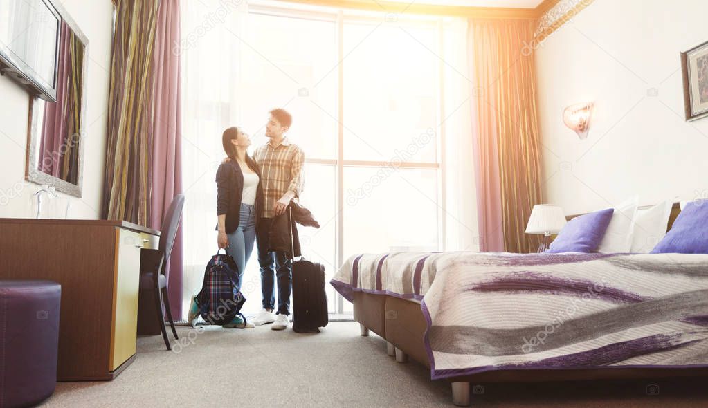 Young couple arrived to hotel room on honeymoon
