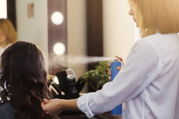 Estilista haciendo peinado rizado en salón de belleza —  Fotos de Stock