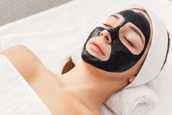 Young girl with purifying black face mask