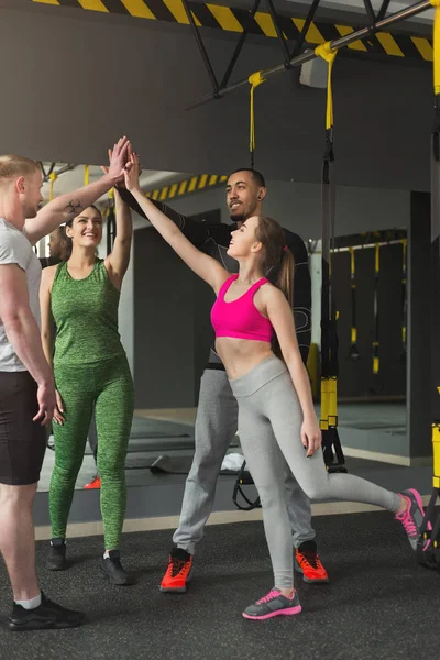 Grupo de pessoas desportivas dando high-five no ginásio — Fotografia de Stock